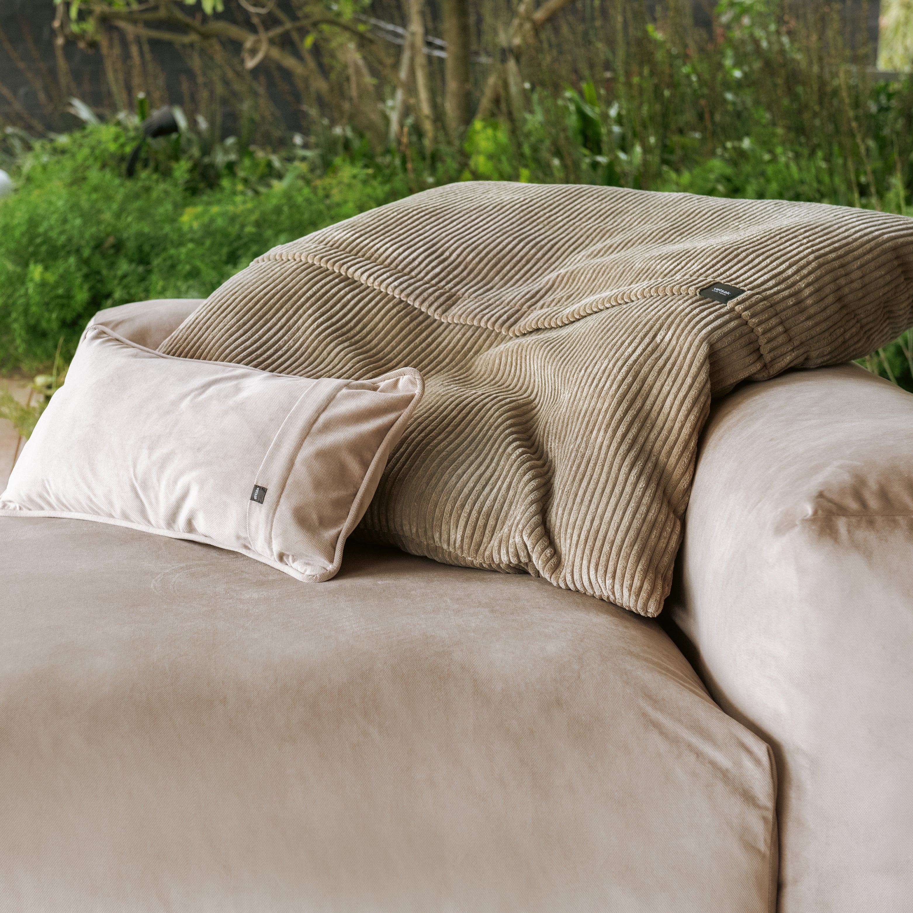 Vetsak Sofa in Velvet mit Cordkissen in Naturtönen auf Terrasse mit Blick ins Grüne