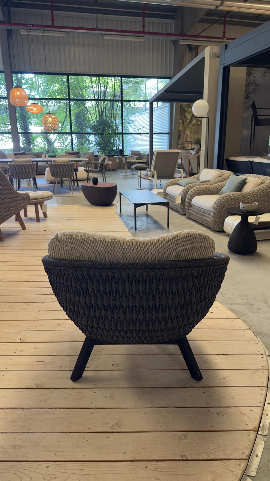 Manutti SANDUA garden armchair made of black teak, on display in the garden section