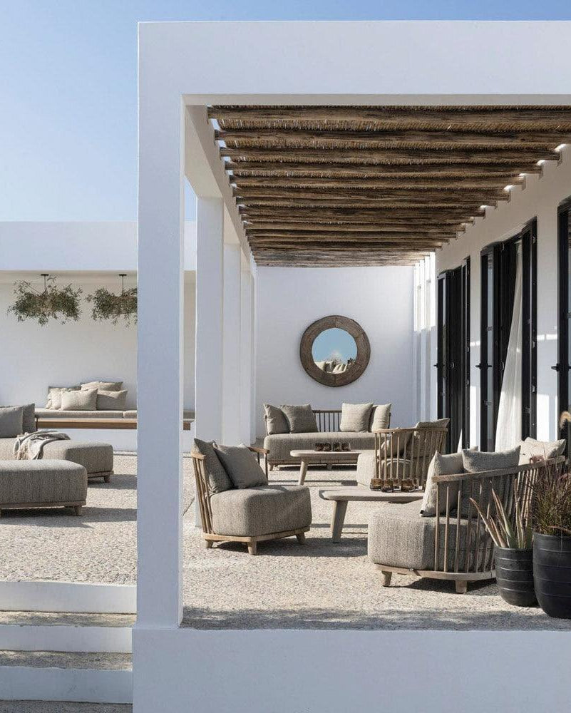 Gartensessel LOUNGE CAROL von Gommaire im Garten – eleganter Teakholz-Sessel mit wetterfestem Kissen, ergänzt durch minimalistischen Beistelltisch