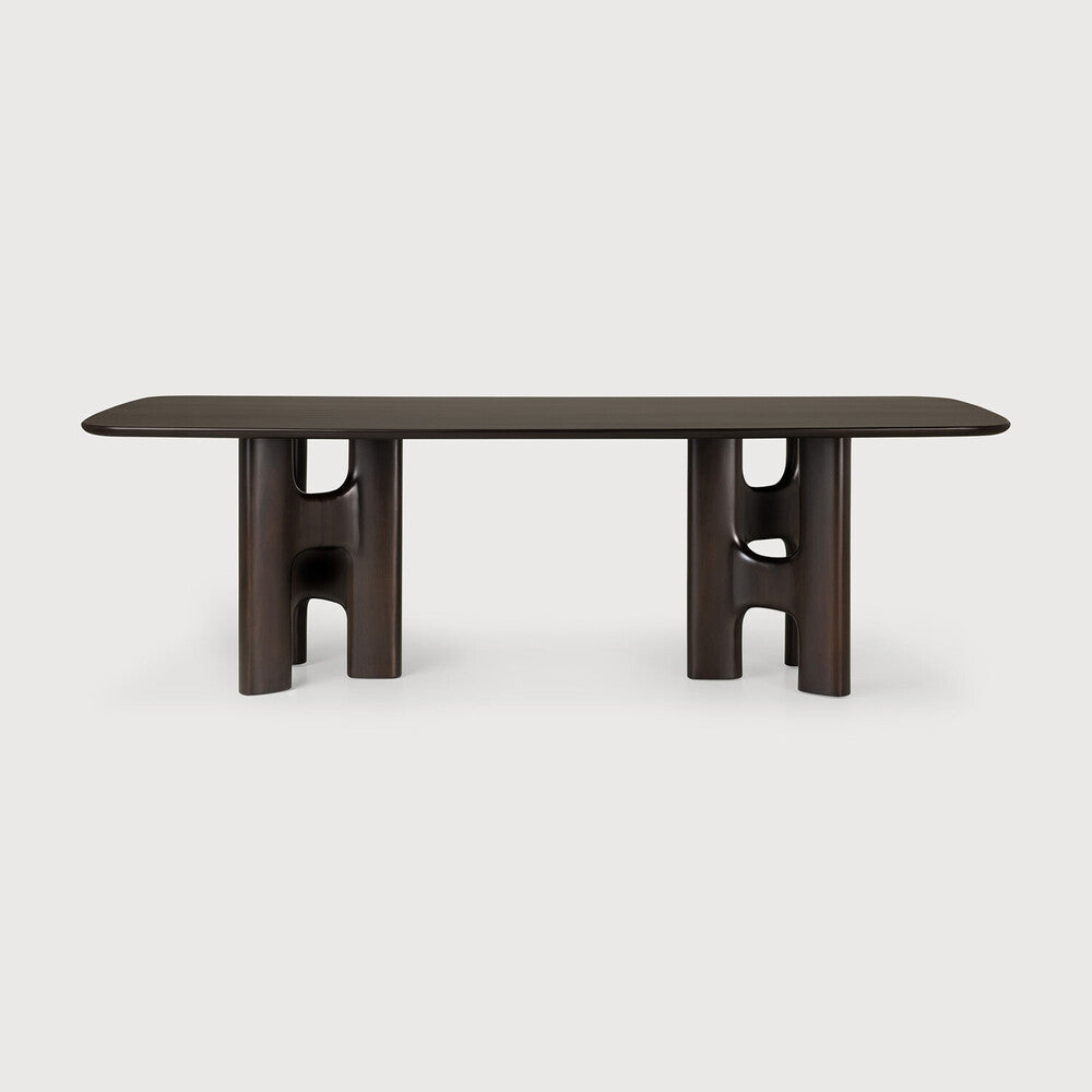 Ethnicraft FLOW solid wood dining table with a gently rounded tabletop and sculptural table legs, as seen from the front.