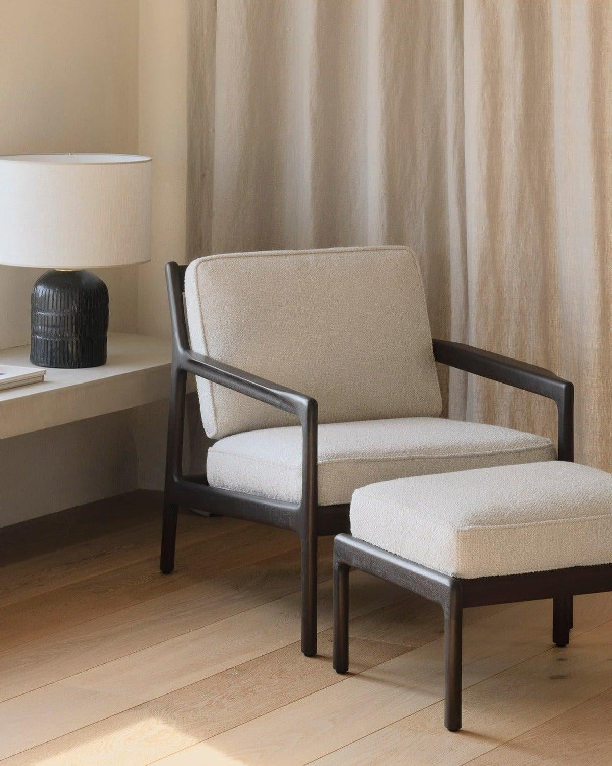 Ethnicraft JACK lounge chair made of dark brown lacquered mahogany with ivory leather cushions and finely crafted wooden details.