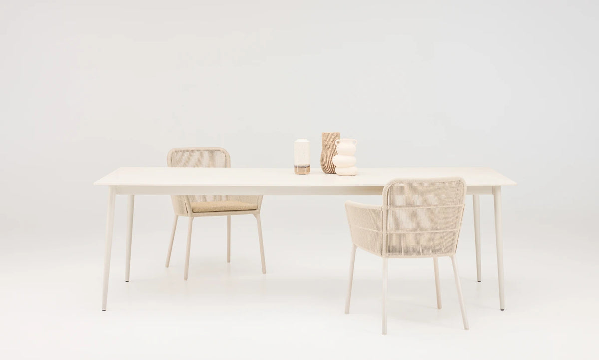 Vincent Sheppard AKARI Garden Chair with Armrests at an Outdoor Dining Table